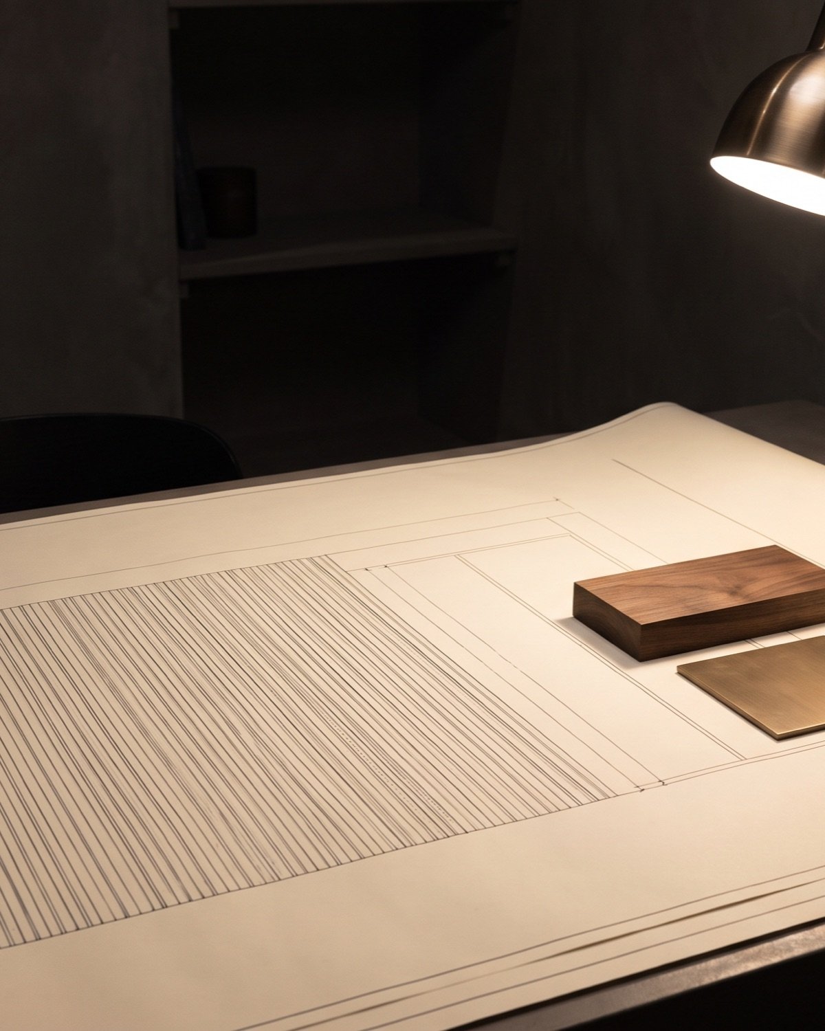 Elevation drawing of a slat wall on a studio desk beside walnut and bronze samples