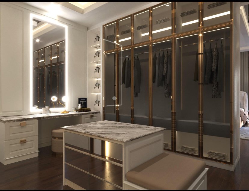 Dressing room with bronze-framed glass wardrobes and a marble island