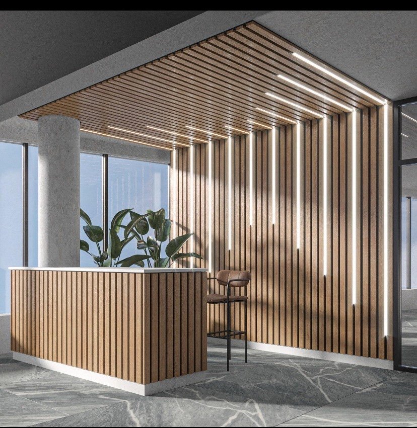 Wood slat wall wrapping into a slat ceiling with integrated linear lighting over a reception desk