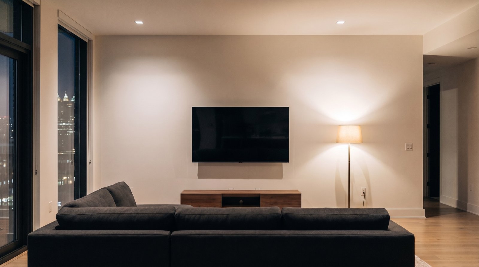 The original living room wall: painted drywall, a wall-mounted television and a console